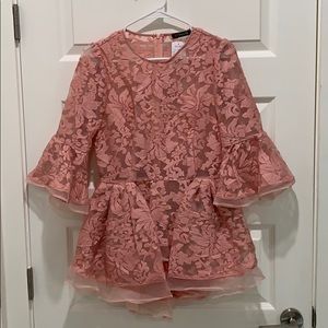 Peplum top with back zipper and bell sleeves.